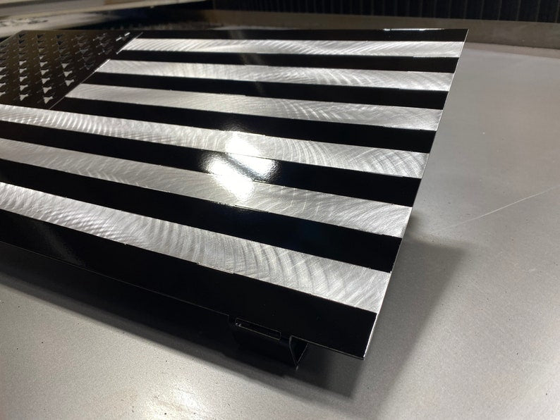 Black and silver American flag made from marine-grade aluminum with floating wall mount
