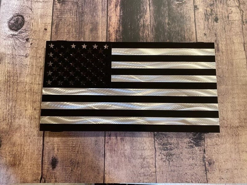 Black and silver American flag made from marine-grade aluminum with floating wall mount