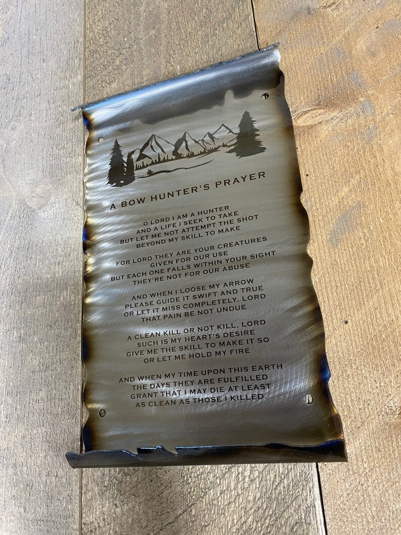 metal scroll featuring a mountain and engraved Bow Hunter's Prayer