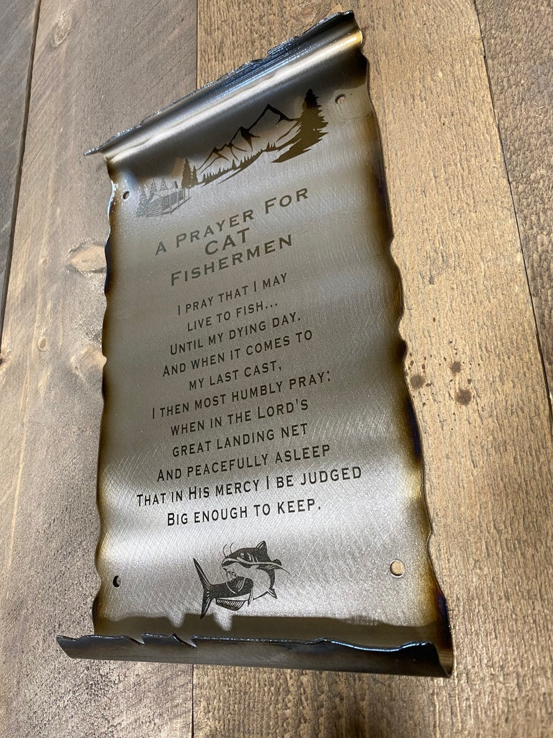 Whimsical metal scroll featuring a cat fishing and engraved Fisherman’s Prayer