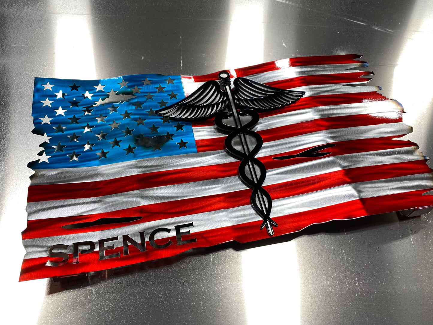 Metal American flag with raised Caduceus emblem for nurses