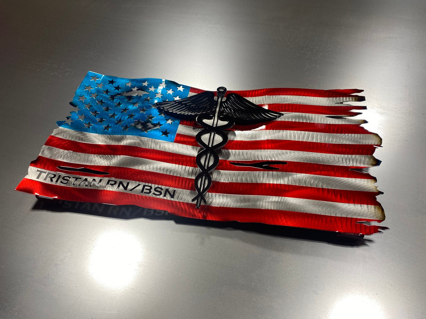 Metal American flag with raised Caduceus emblem for nurses