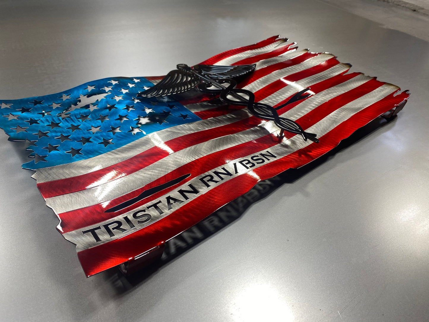 Metal American flag with raised Caduceus emblem for nurses