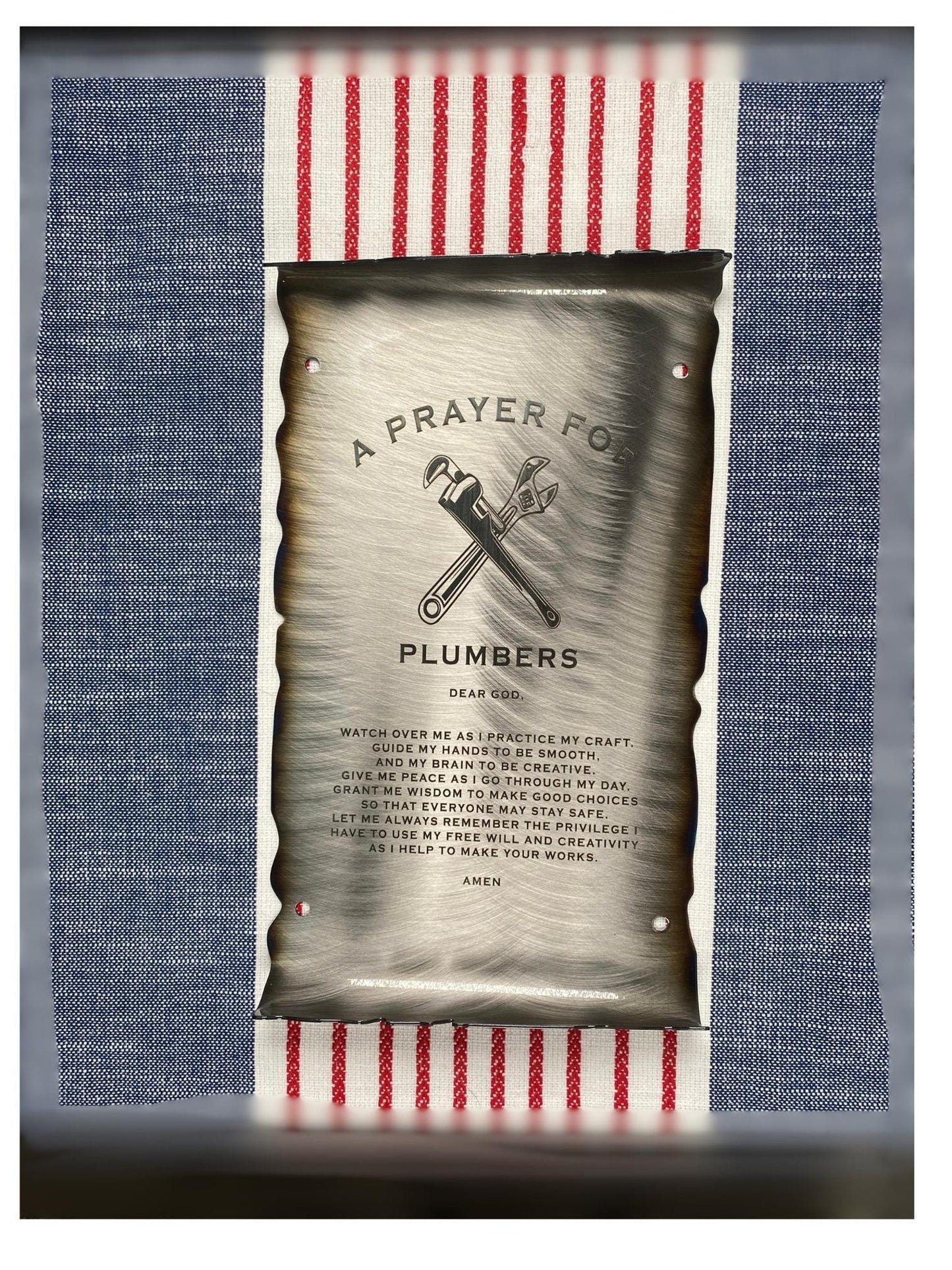 CNC cut metal Plumber’s Prayer scroll with heat patina finish and powder coat, made from American steel