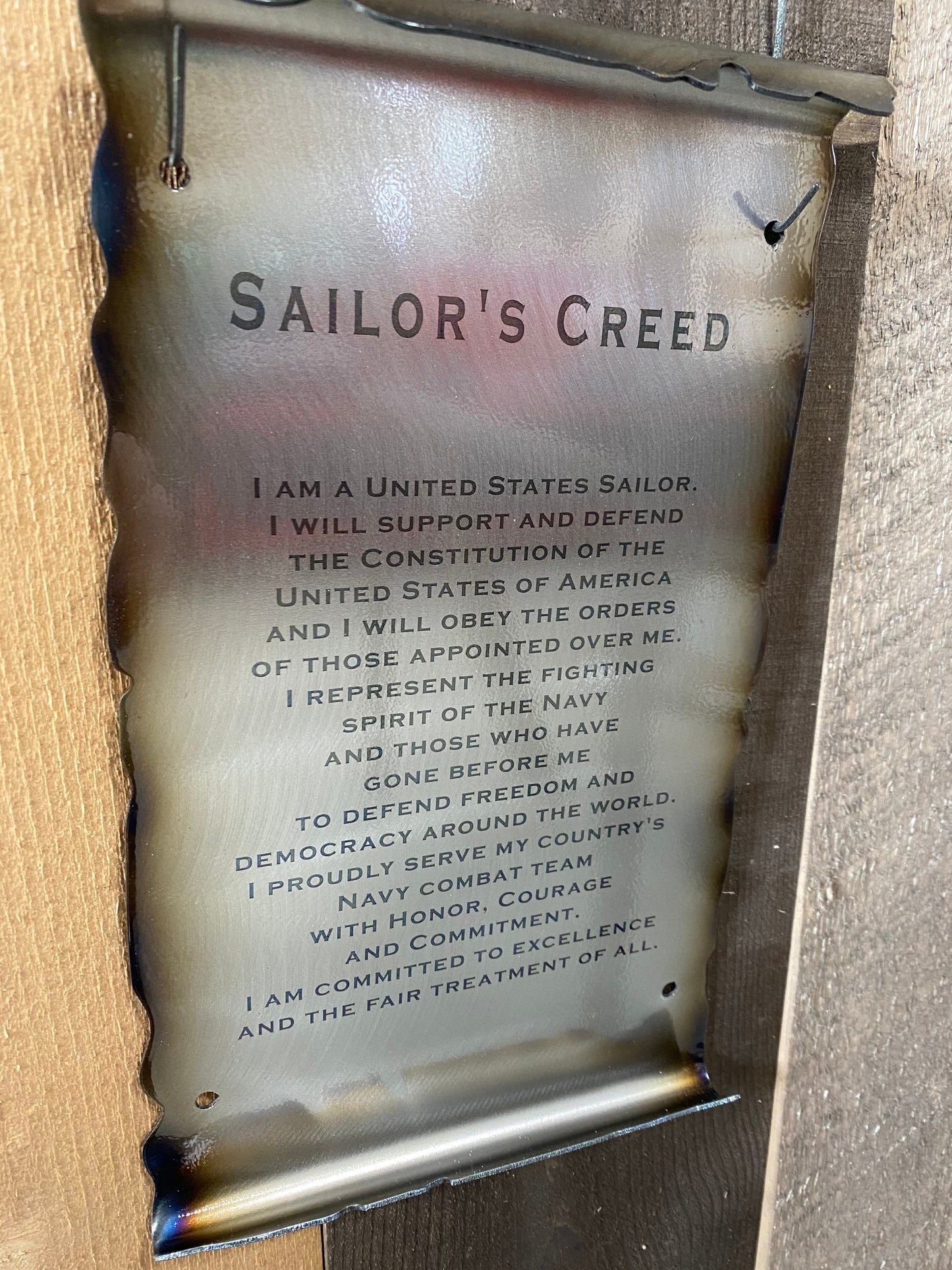 Metal Sailor’s Creed scroll laser engraved on American steel with powder coat and patina, 6x10 inches