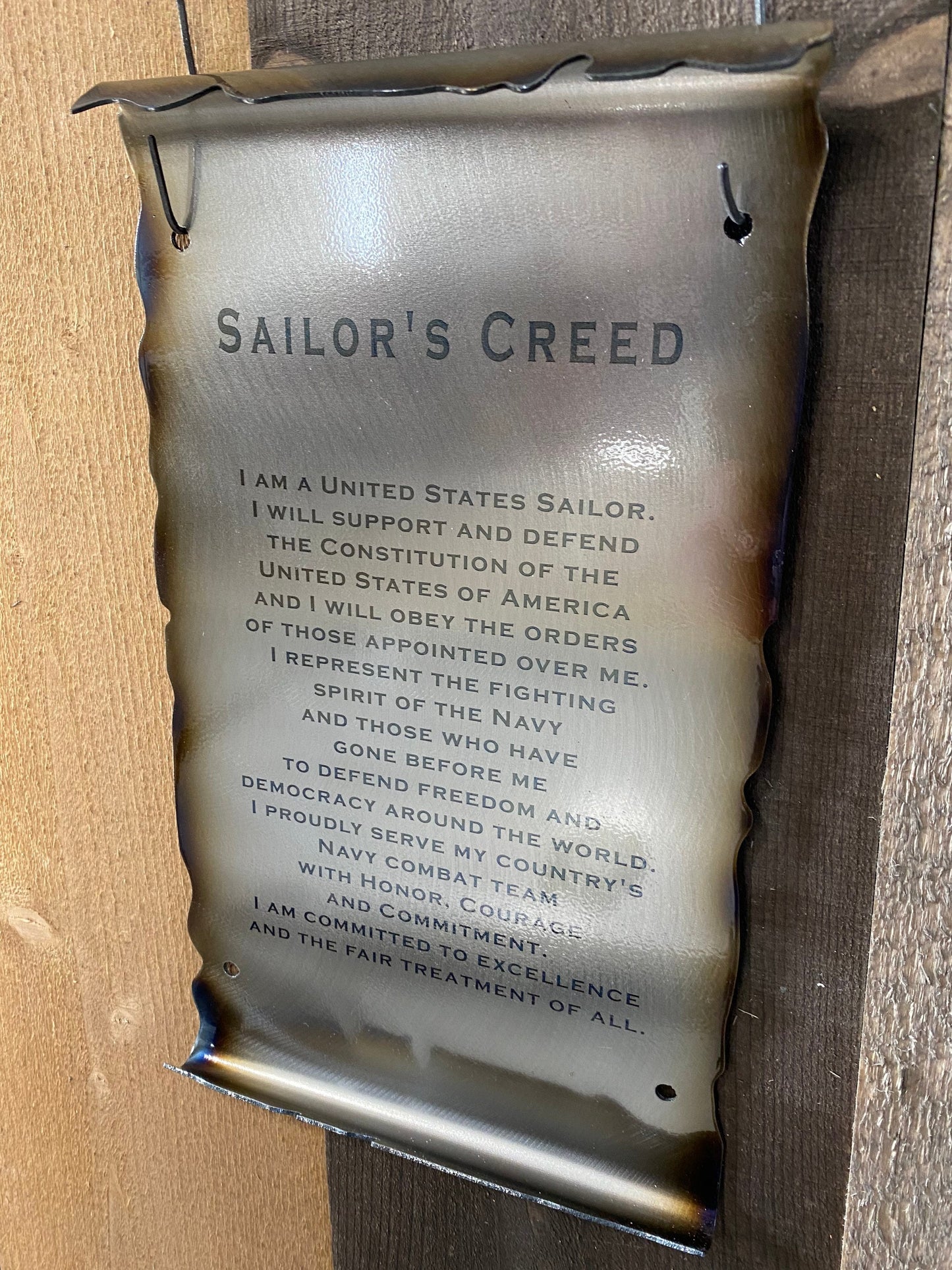 Metal Sailor’s Creed scroll laser engraved on American steel with powder coat and patina, 6x10 inches