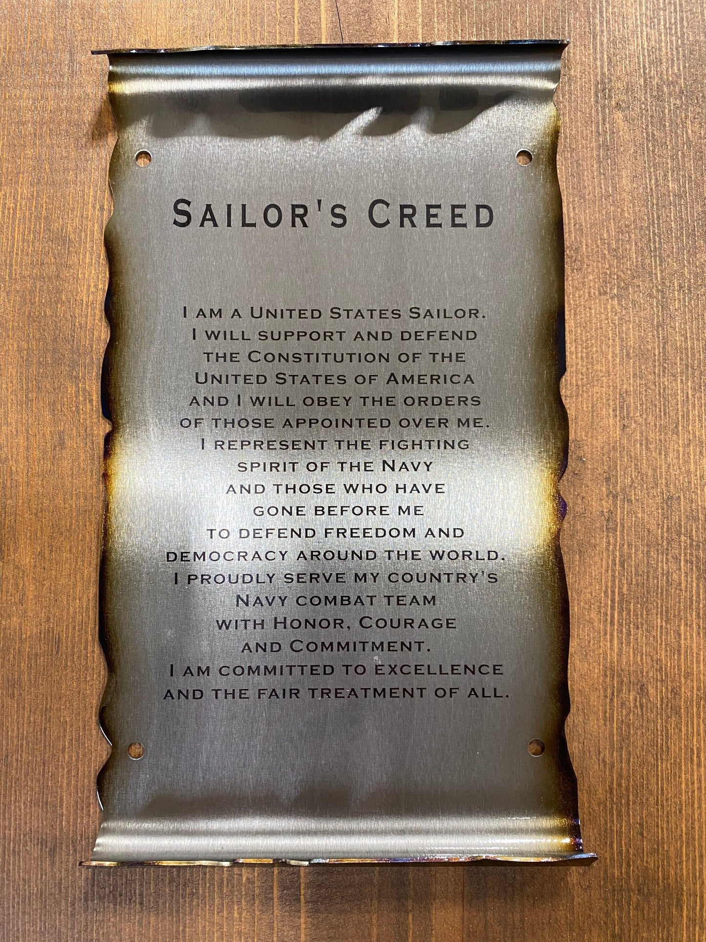 Metal Sailor’s Creed scroll laser engraved on American steel with powder coat and patina, 6x10 inches