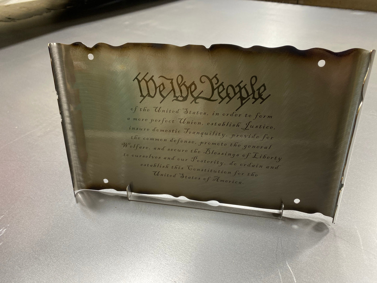 Laser engraved We The People metal sign with patriotic scrollwork