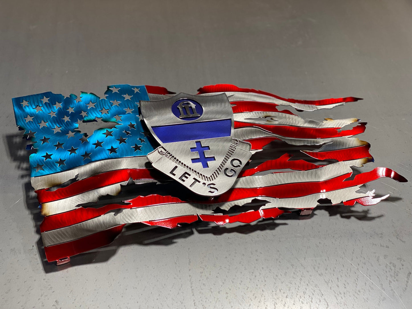 Metal tattered American flag with 325th Airborne Infantry Regiment emblem

