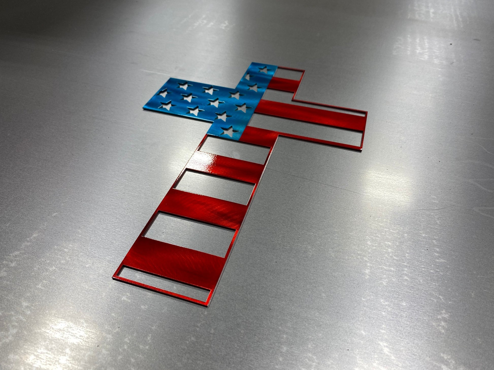 Metal cross wall art with American flag design representing faith and patriotism