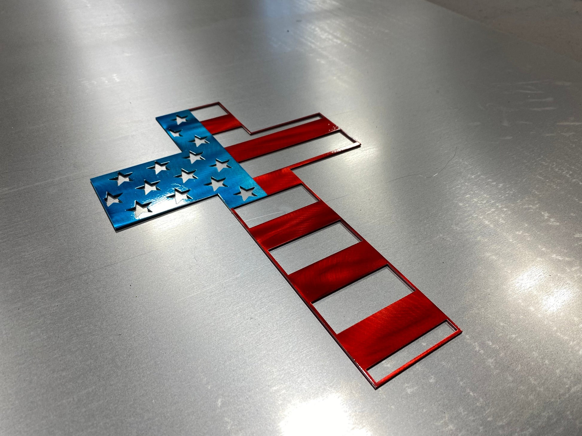 Metal cross wall art with American flag design representing faith and patriotism