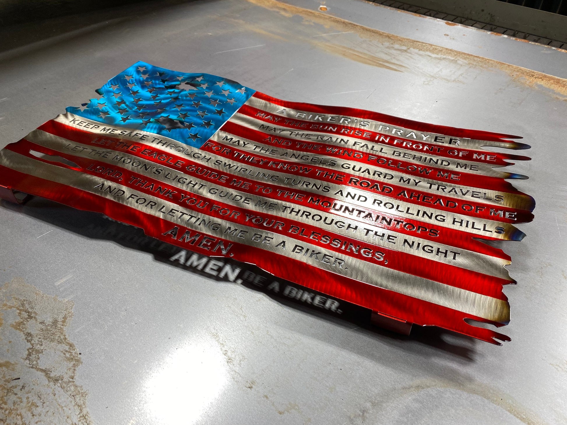 Wavy American flag metal art with biker prayer and heat-colored finish