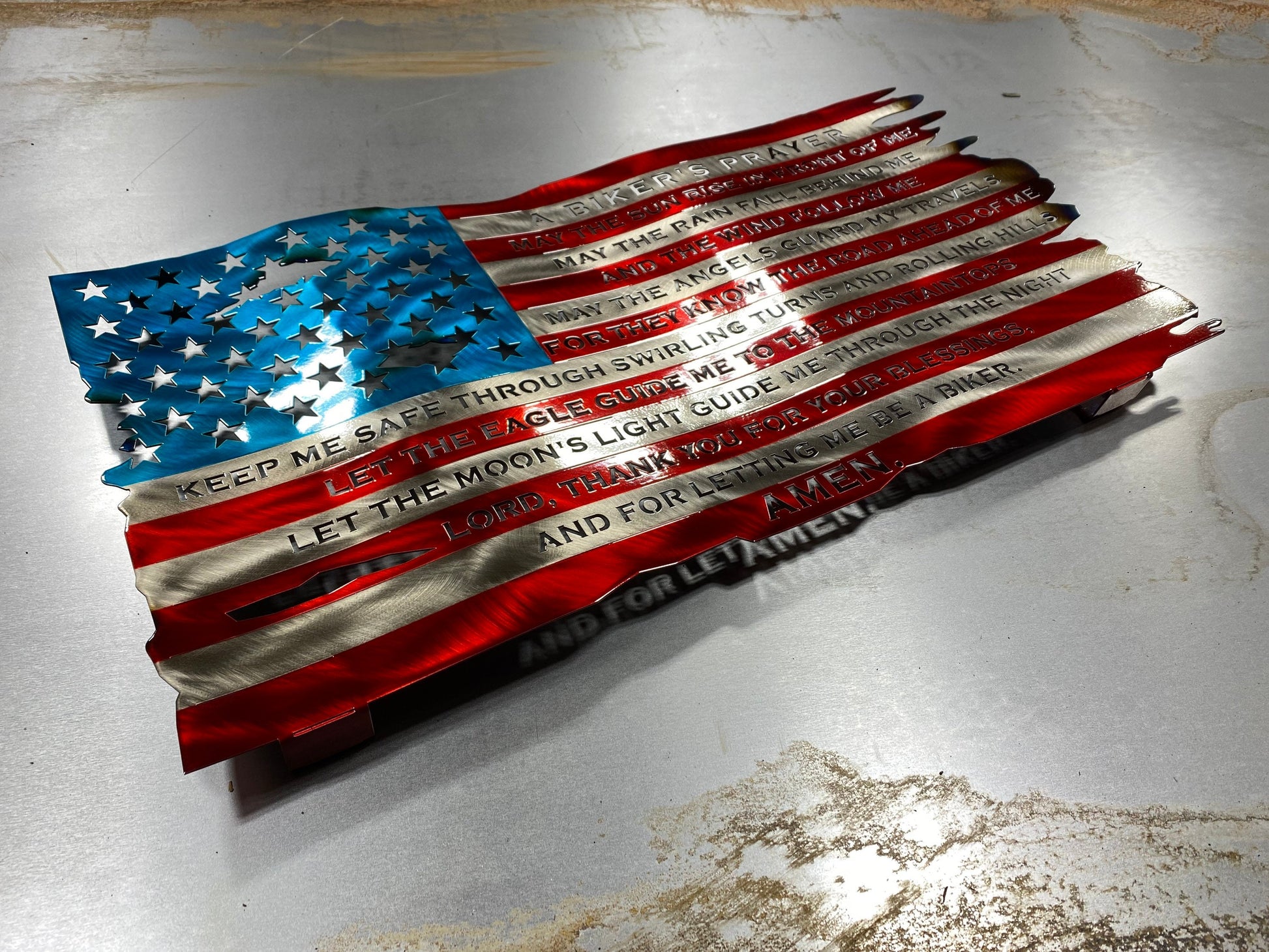Wavy American flag metal art with biker prayer and heat-colored finish