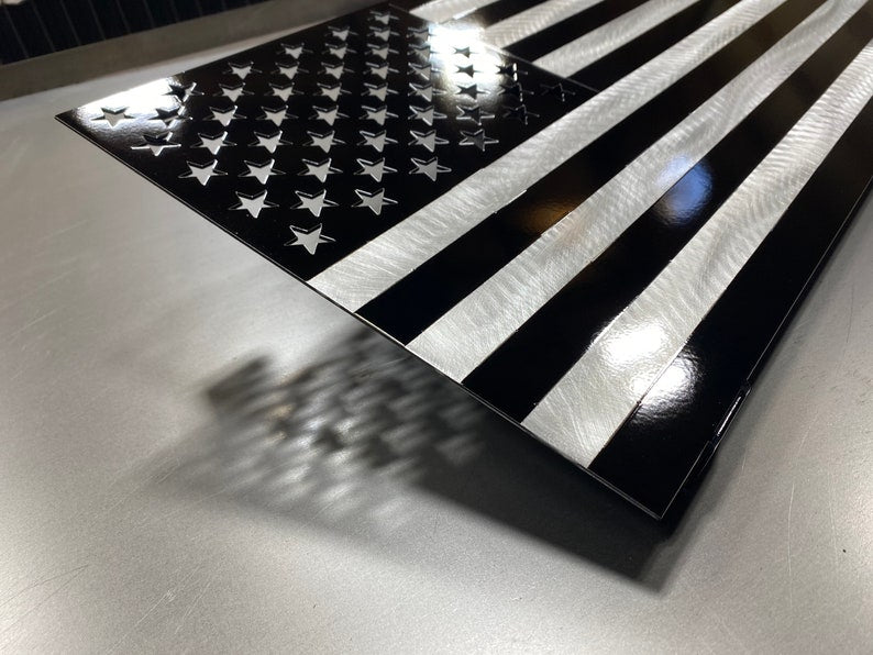 Black and silver American flag made from marine-grade aluminum with floating wall mount