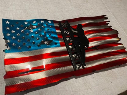 Metal American flag with lineman climbing cell tower silhouette