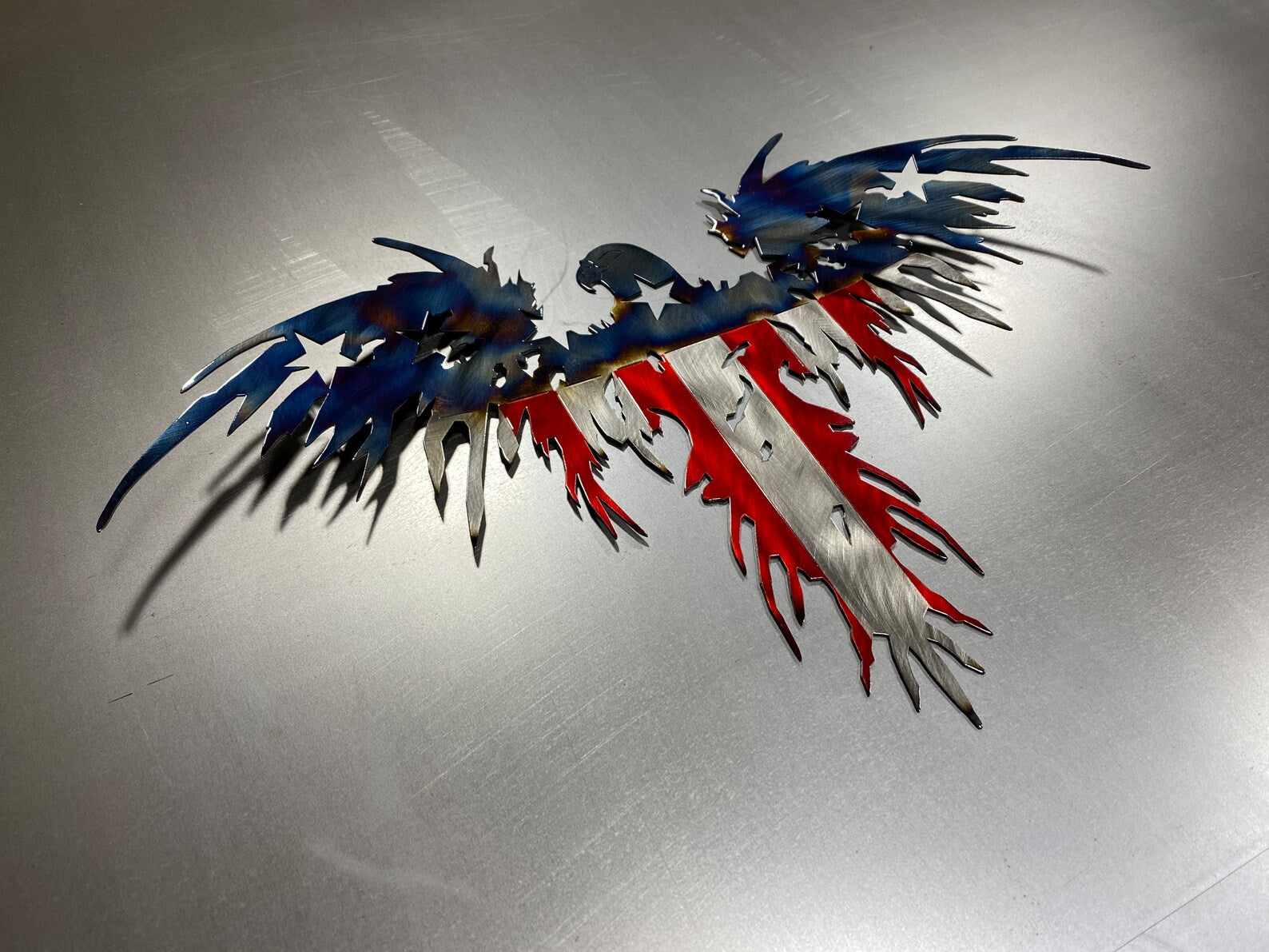 Heat Patina American Eagle Flag handcrafted from American steel with a wavy wing design and battle-worn American flag finish