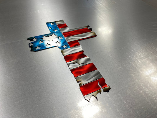 Metal cross wall decor with tattered American flag overlay

