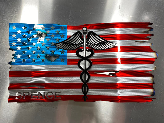 Metal American flag with raised Caduceus emblem for nurses