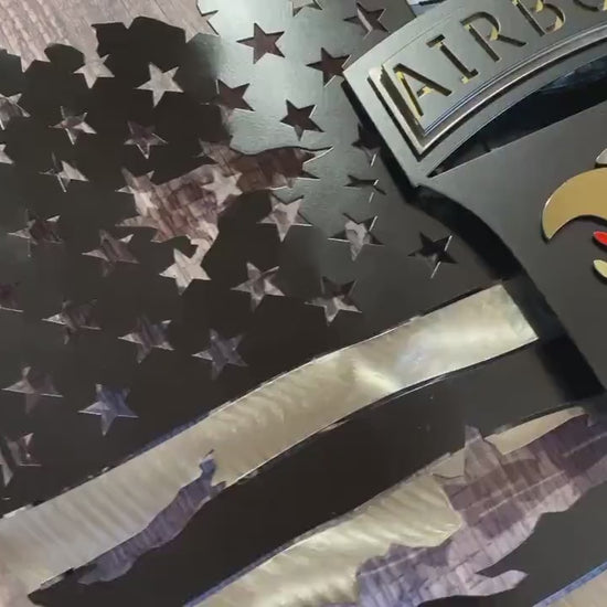 Tattered metal American flag featuring the 101st Airborne Division emblem in black and silver.