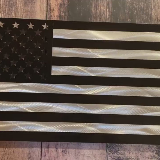 Black and silver American flag made from marine-grade aluminum with floating wall mount