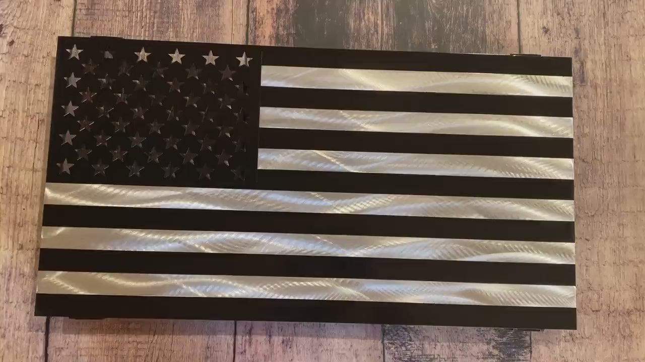 Black and silver American flag made from marine-grade aluminum with floating wall mount