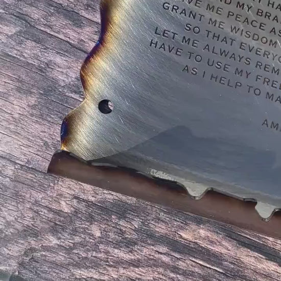 CNC cut metal Plumber’s Prayer scroll with heat patina finish and powder coat, made from American steel
