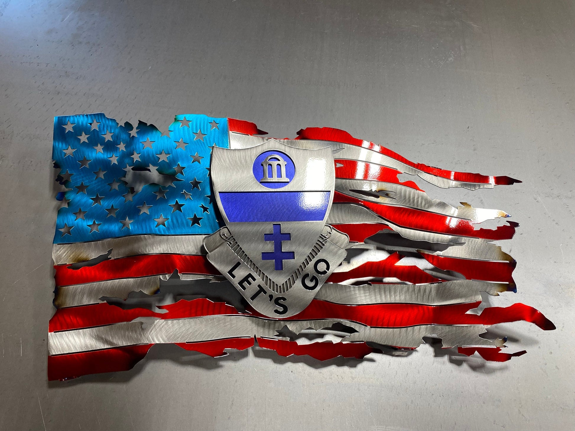 Metal tattered American flag with 325th Airborne Infantry Regiment emblem

