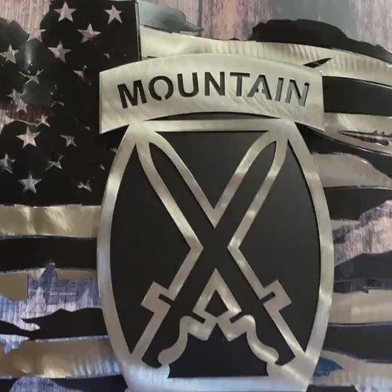 Battle-worn American flag wall art with floating 10th Mountain Division emblem in layered steel.