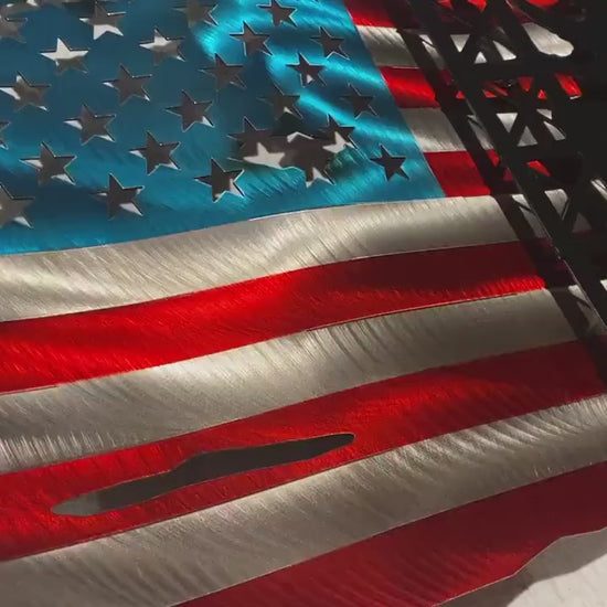 Metal American flag with lineman climbing cell tower silhouette