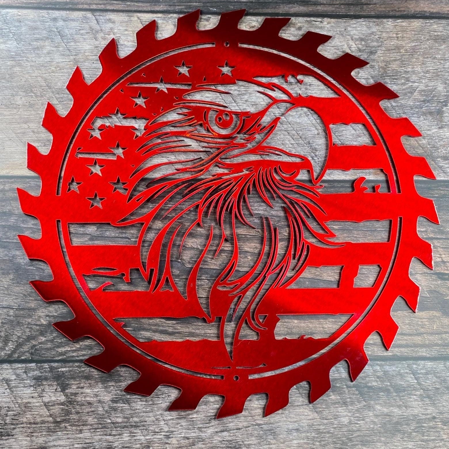Rustic steel wall art with American flag and eagle inside a saw blade
