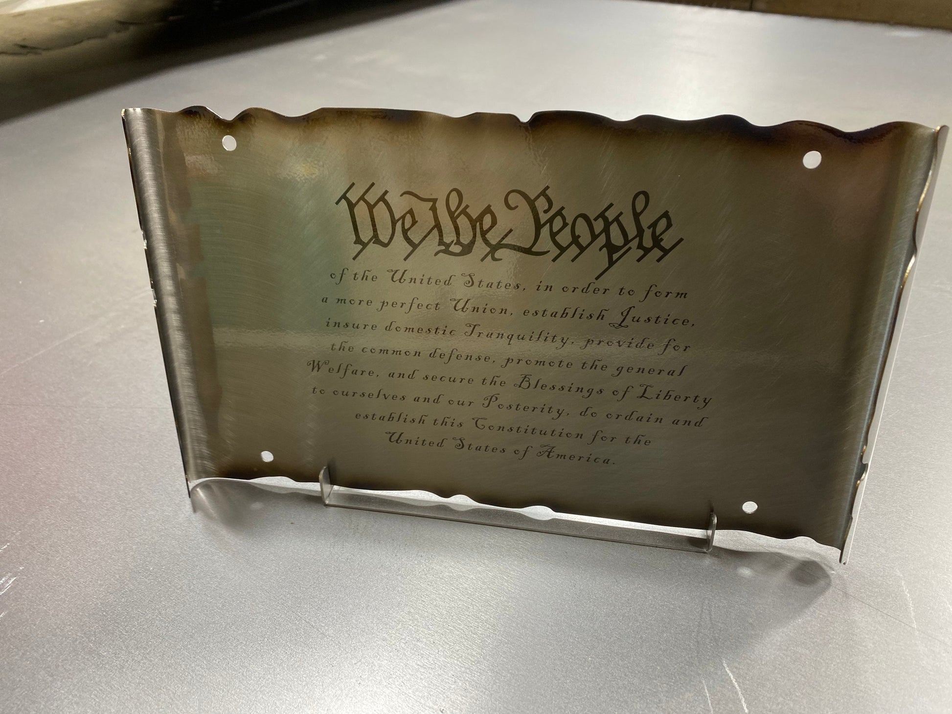 Laser engraved We The People metal sign with patriotic scrollwork