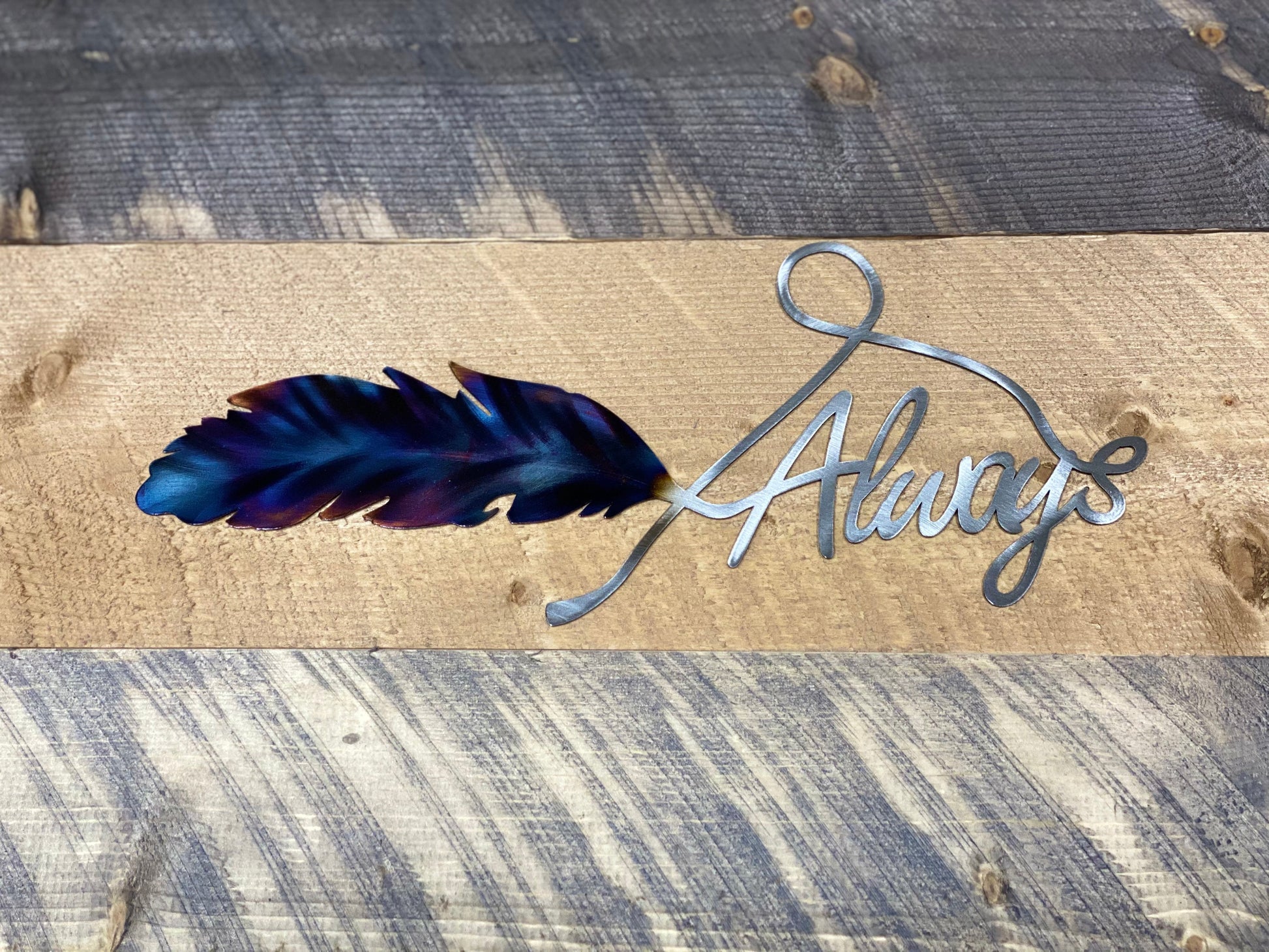 Always Feather metal wall art, handcrafted from American steel, heat-treated for blue and purple hues, and finished with a clear powder coat 