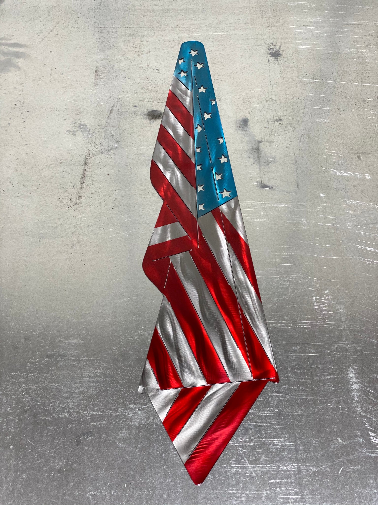 Metal Draped American Flag, handcrafted from American steel with a grind pattern and three-stage powder-coated finish by CnS CnC.