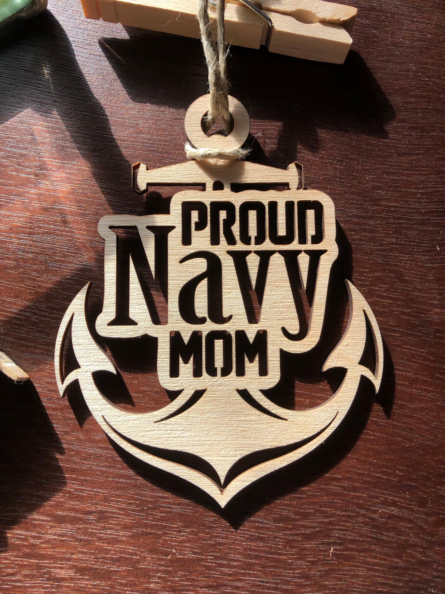 Proud Navy Mom ornament laser-cut from Baltic Birch, featuring intricate details and perfect for Christmas tree display.