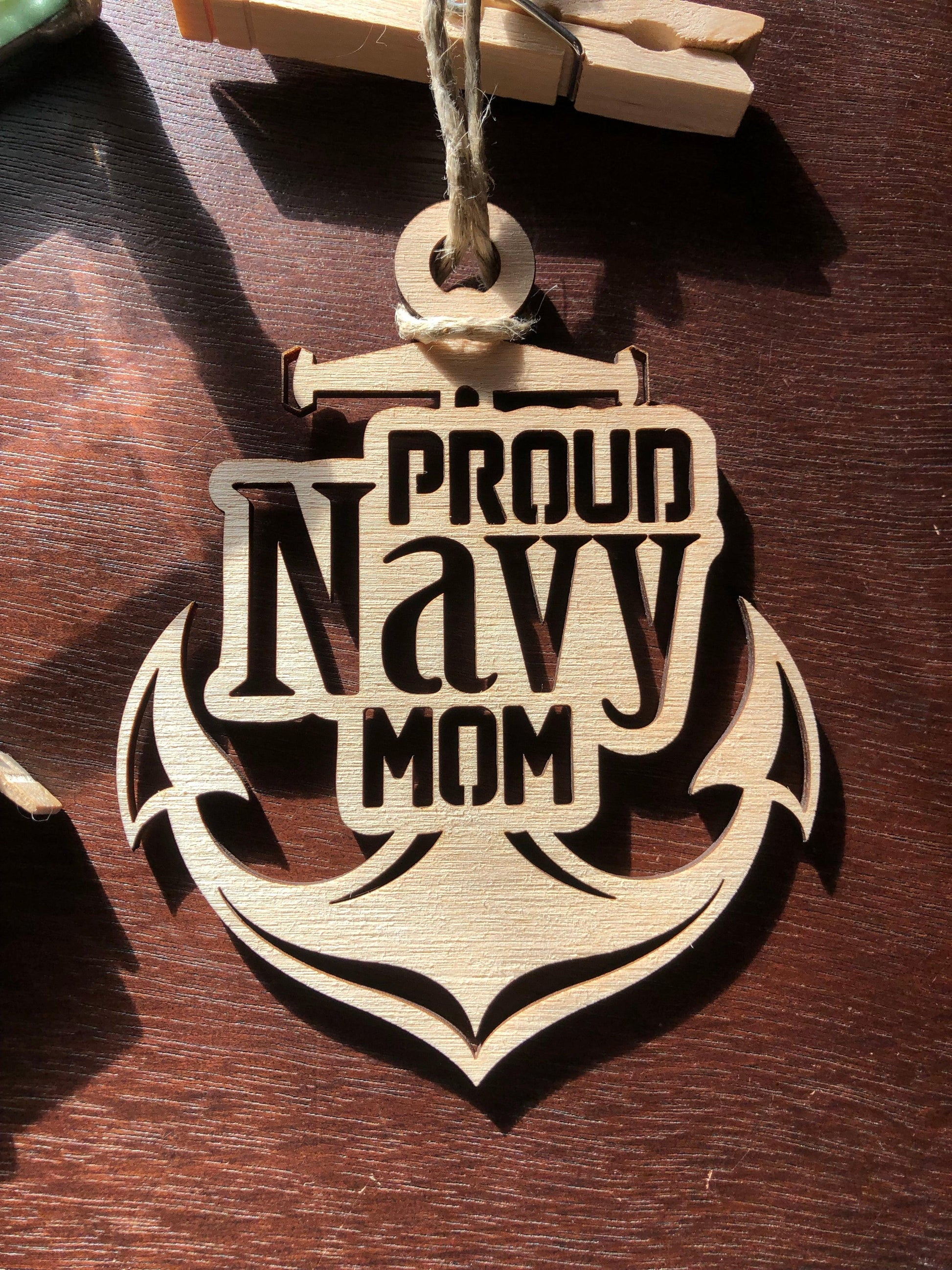 Proud Navy Mom ornament laser-cut from Baltic Birch, featuring intricate details and perfect for Christmas tree display.