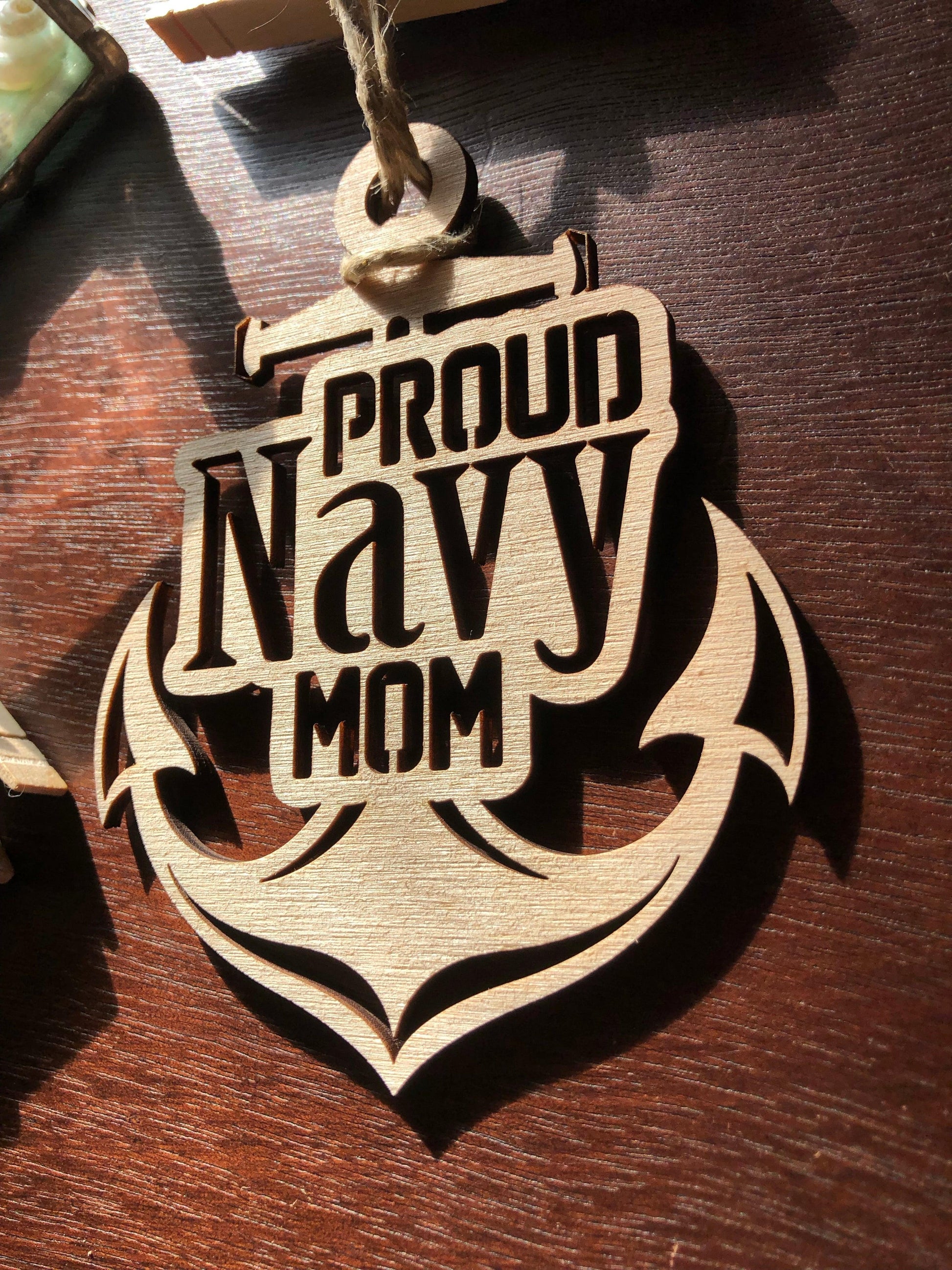 Proud Navy Mom ornament laser-cut from Baltic Birch, featuring intricate details and perfect for Christmas tree display.