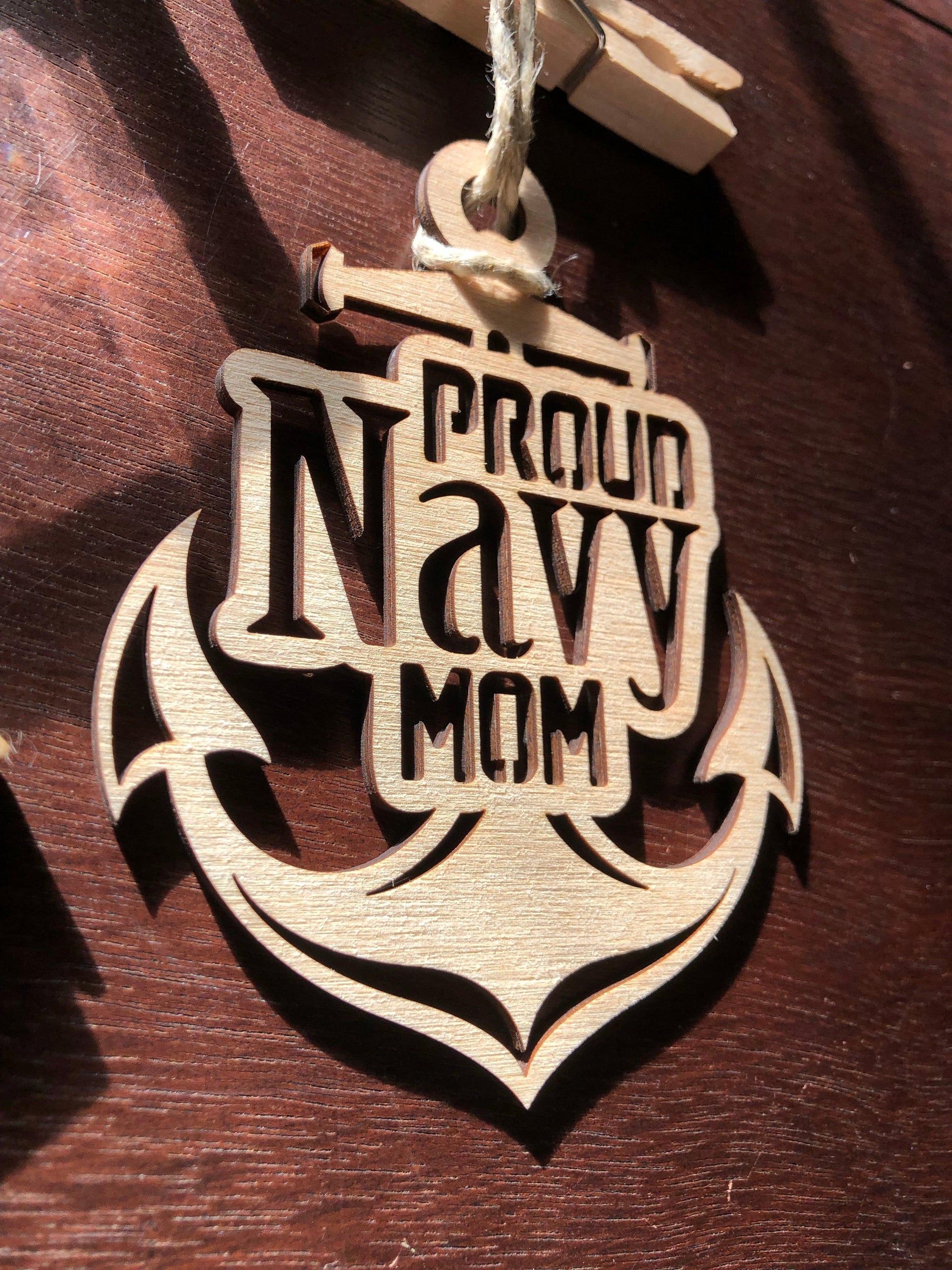 Proud Navy Mom ornament laser-cut from Baltic Birch, featuring intricate details and perfect for Christmas tree display.