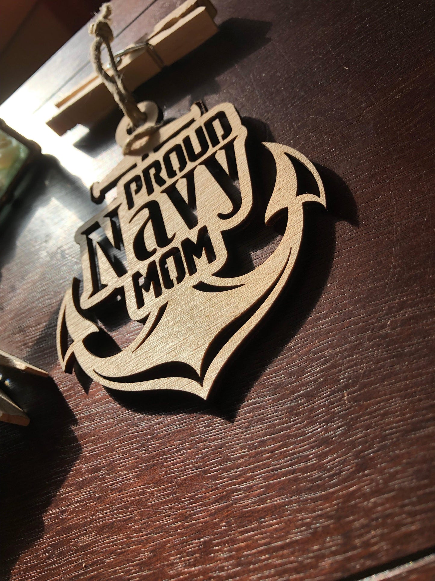 Proud Navy Mom ornament laser-cut from Baltic Birch, featuring intricate details and perfect for Christmas tree display.
