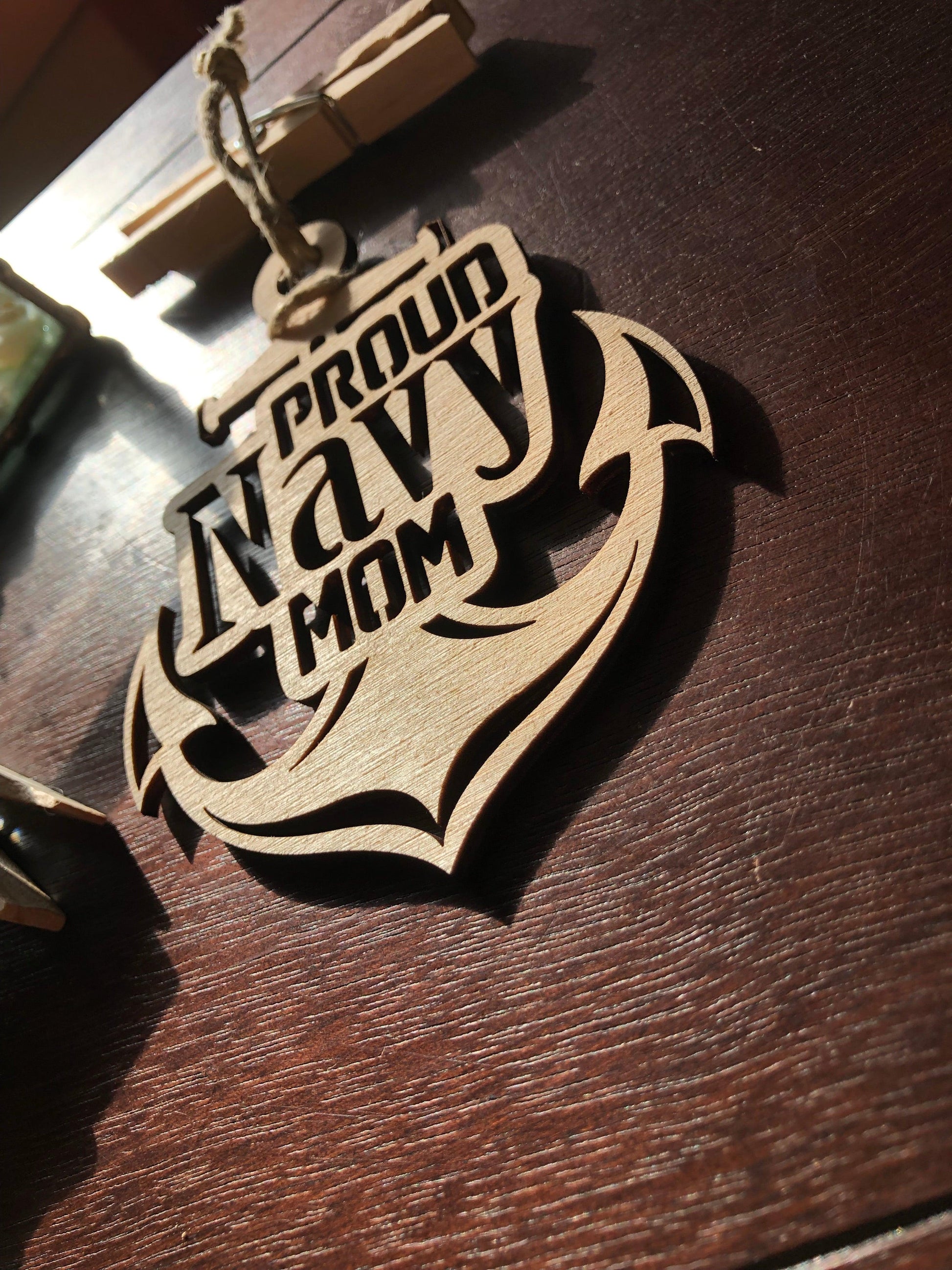 Proud Navy Mom ornament laser-cut from Baltic Birch, featuring intricate details and perfect for Christmas tree display.