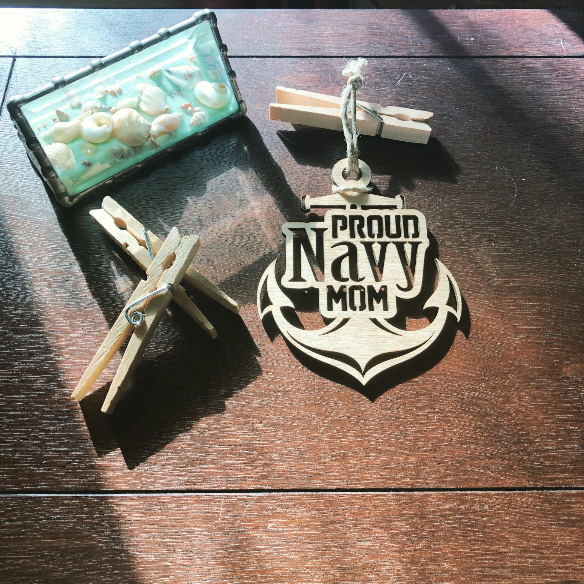 Proud Navy Mom ornament laser-cut from Baltic Birch, featuring intricate details and perfect for Christmas tree display.