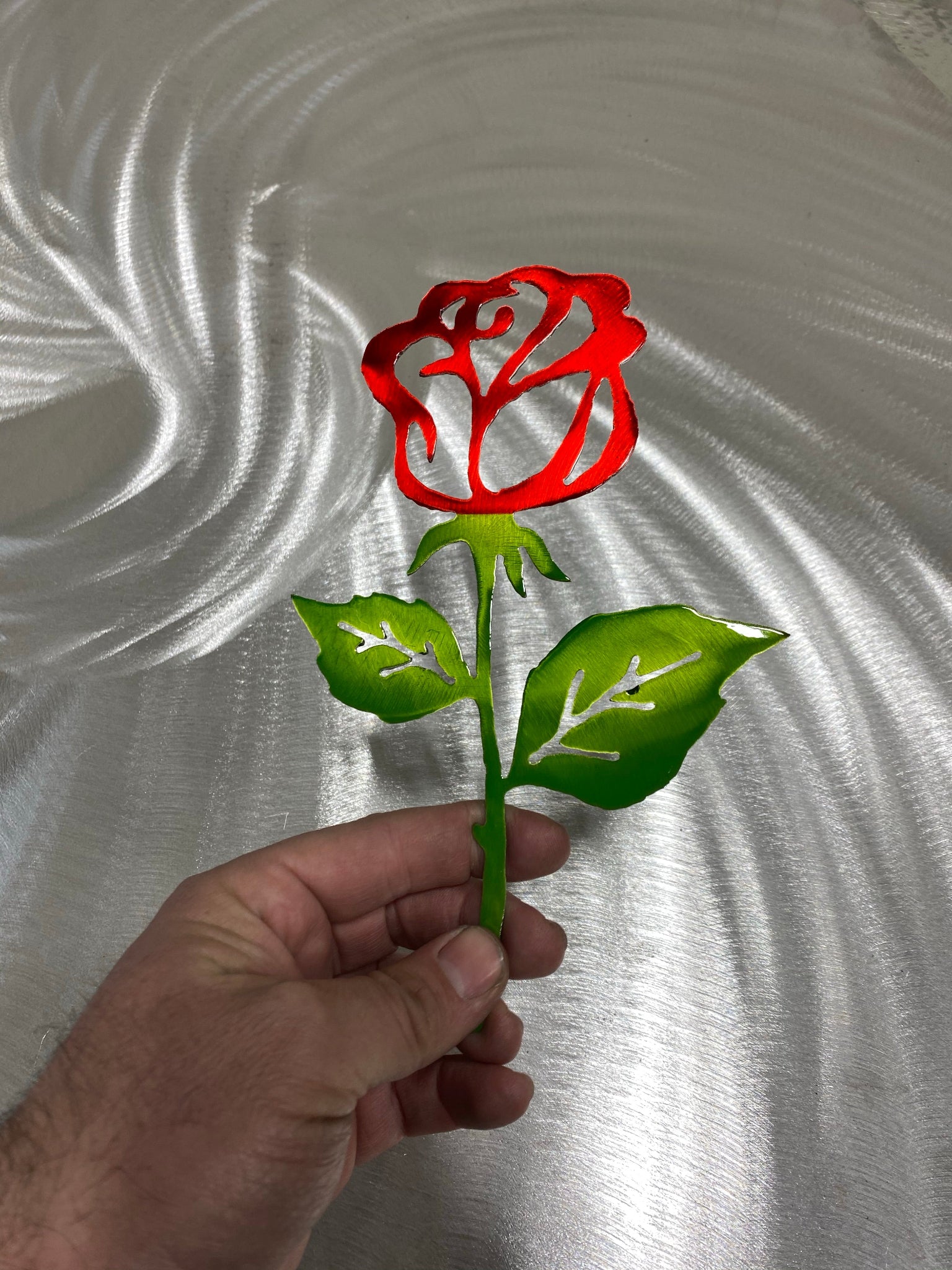 Steel Rose Cutout, handcrafted metal rose with candy red and green powder coat finish, available flat or with a standing base by CnS CnC.