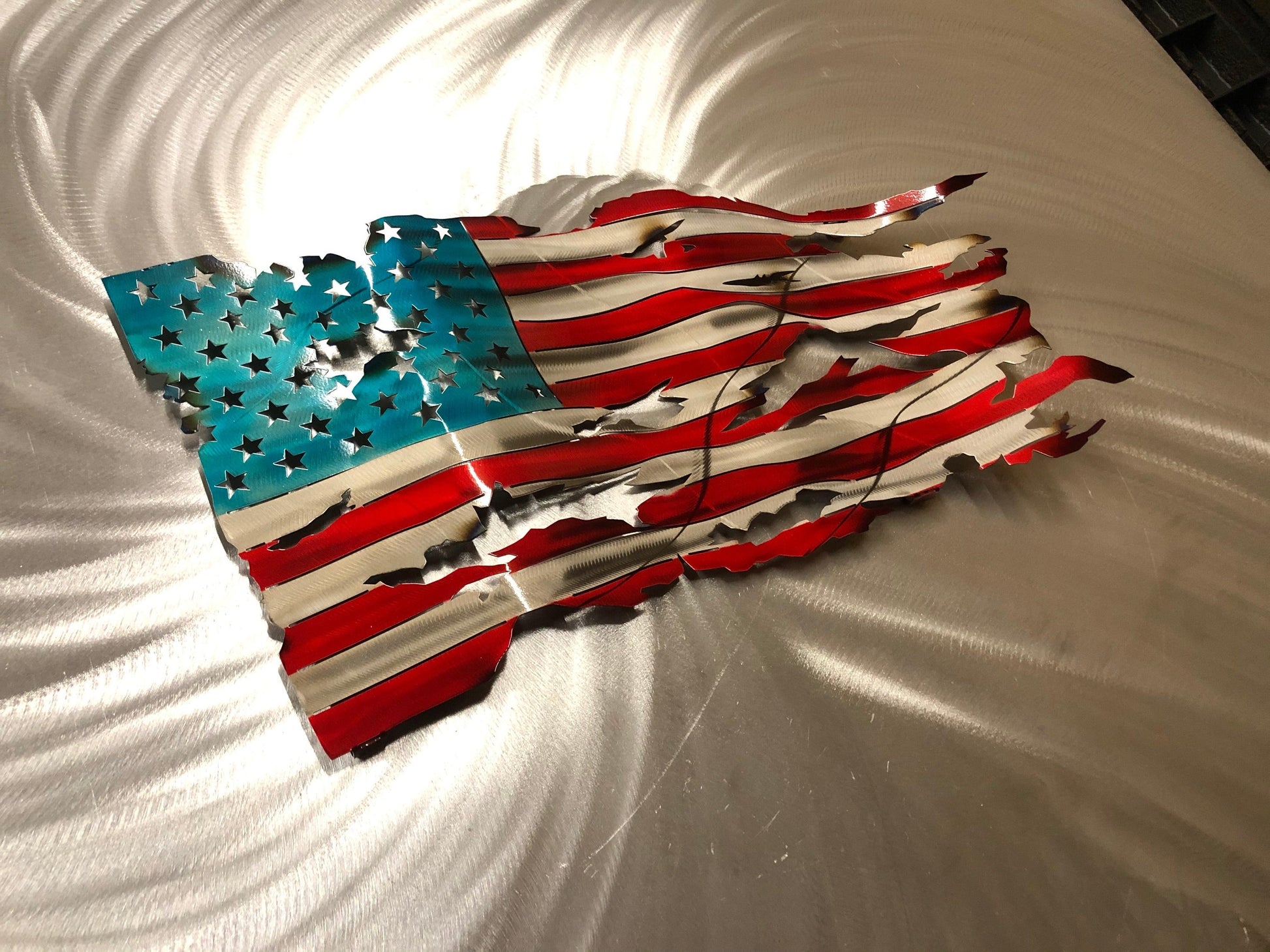 Handcrafted Wavy Battle Worn American Flag made from high-quality American steel with Candy Red and Blue powder coat, 24 inches wide.