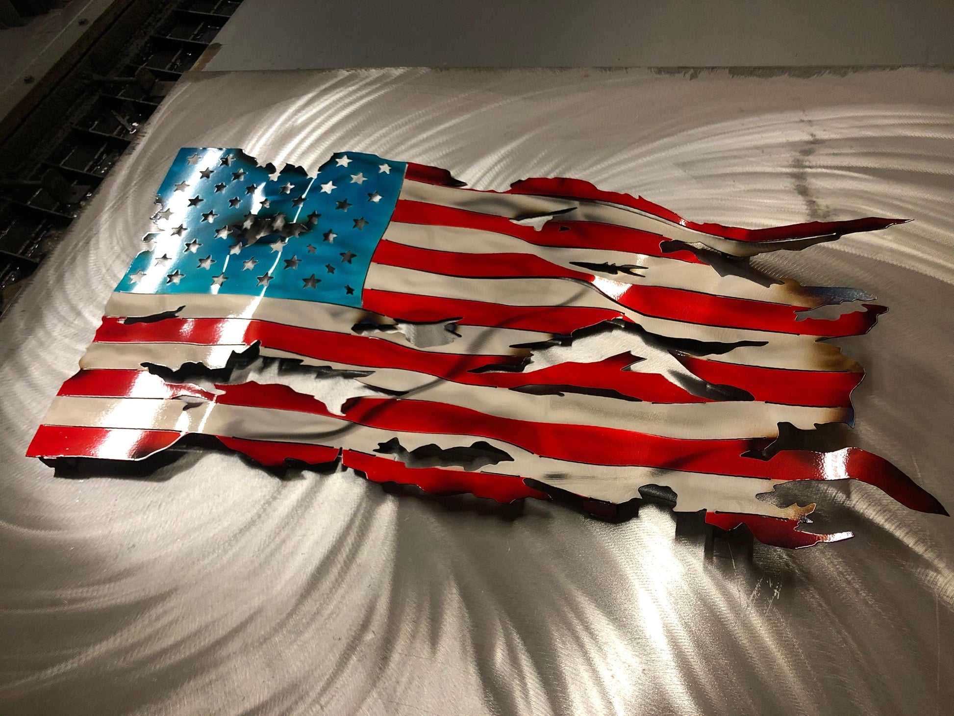 Handcrafted Wavy Battle Worn American Flag made from high-quality American steel with Candy Red and Blue powder coat, 24 inches wide.