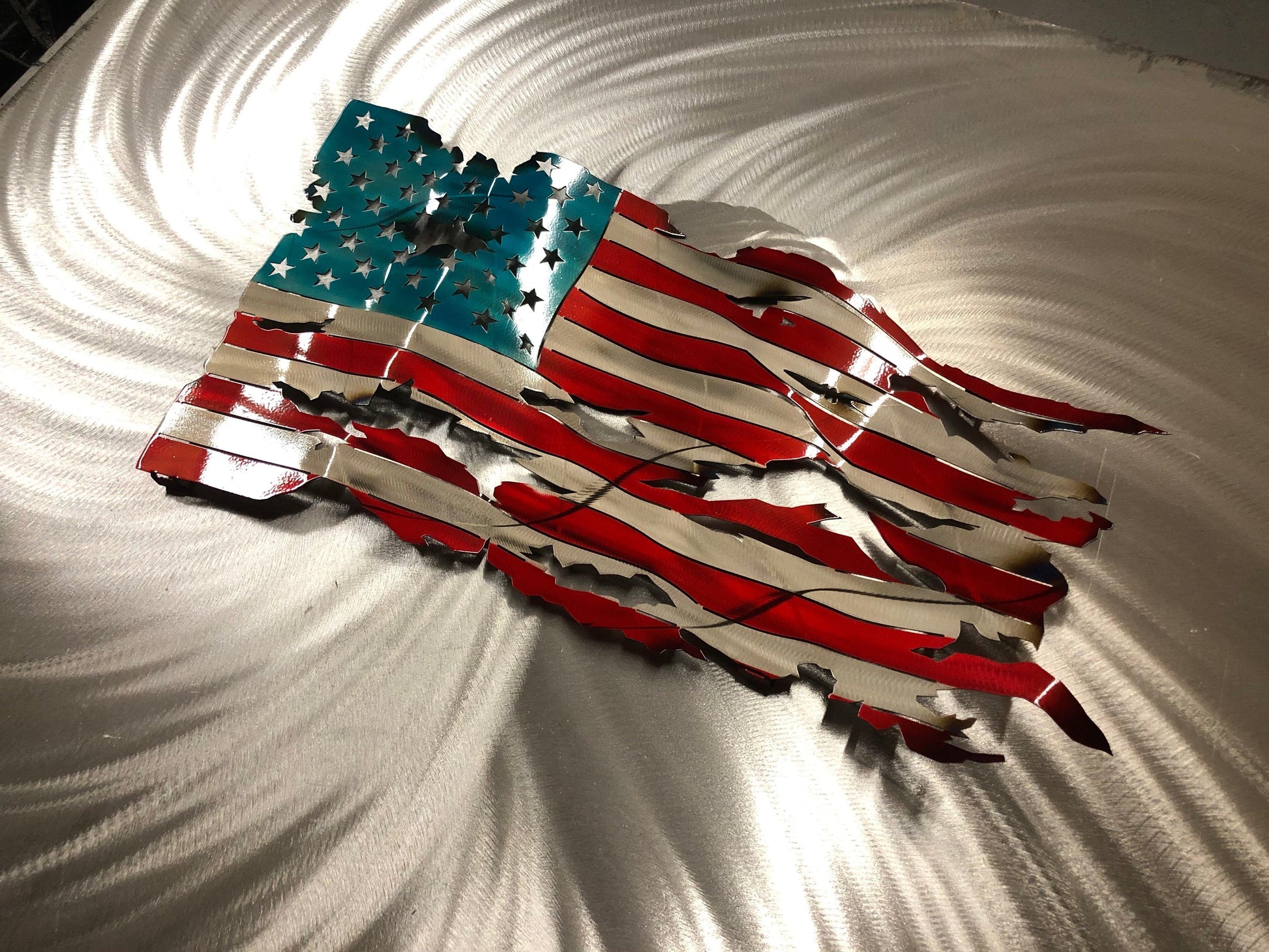 Handcrafted Wavy Battle Worn American Flag made from high-quality American steel with Candy Red and Blue powder coat, 24 inches wide.