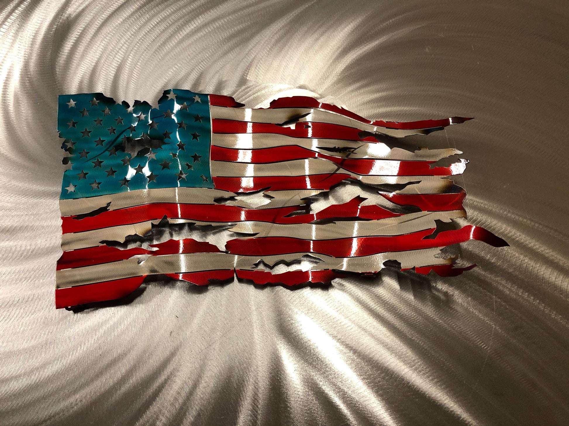 Handcrafted Wavy Battle Worn American Flag made from high-quality American steel with Candy Red and Blue powder coat, 24 inches wide.