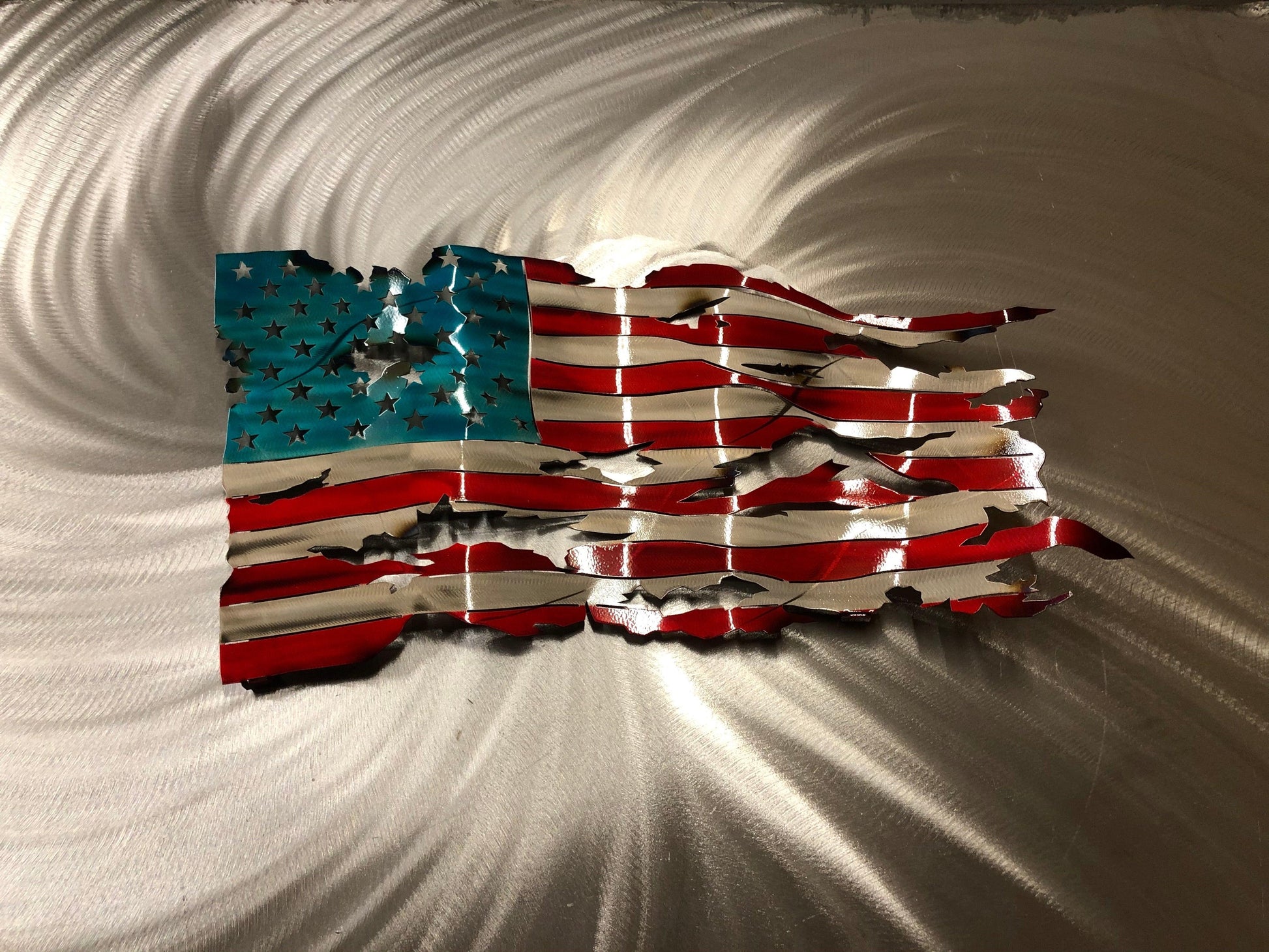 Handcrafted Wavy Battle Worn American Flag made from high-quality American steel with Candy Red and Blue powder coat, 24 inches wide.